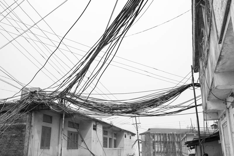 Water cables bundled together and hanging untidily over and between buildings in Kohima, Nagaland, imparting an ugly look to the beautiful capital city